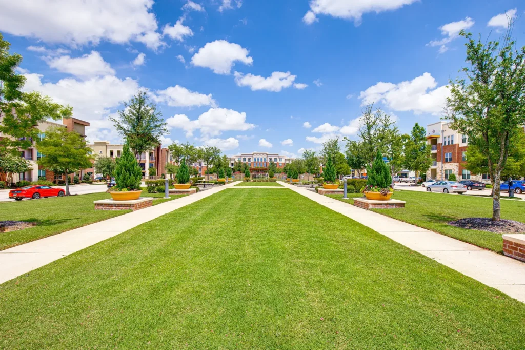 outdoor green space with walking paths and benches