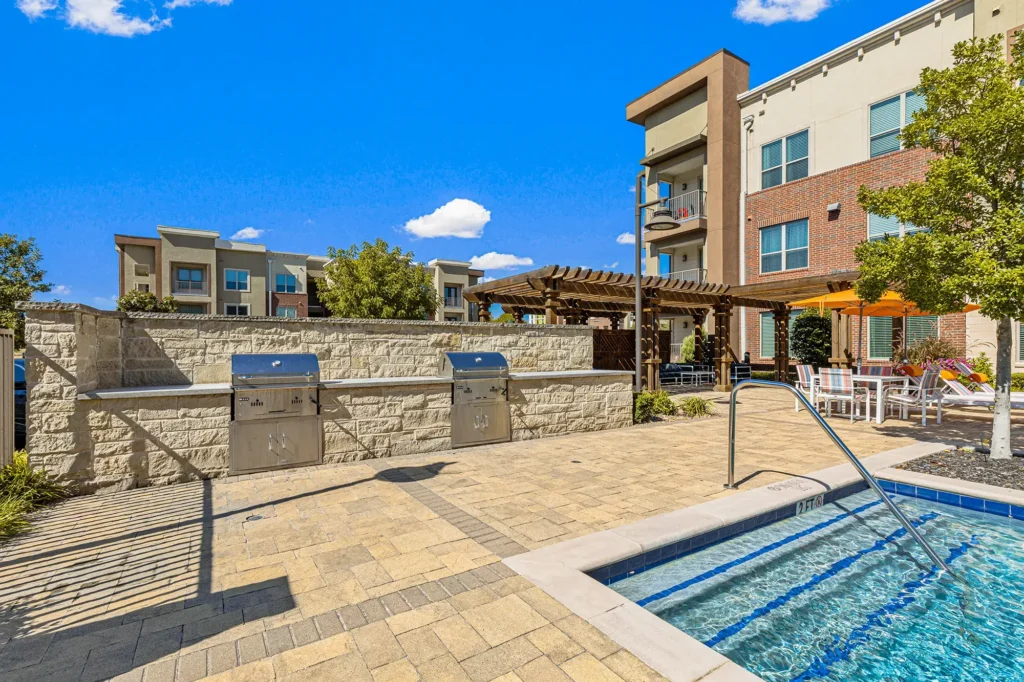 Outdoor grilling stations next to the pool