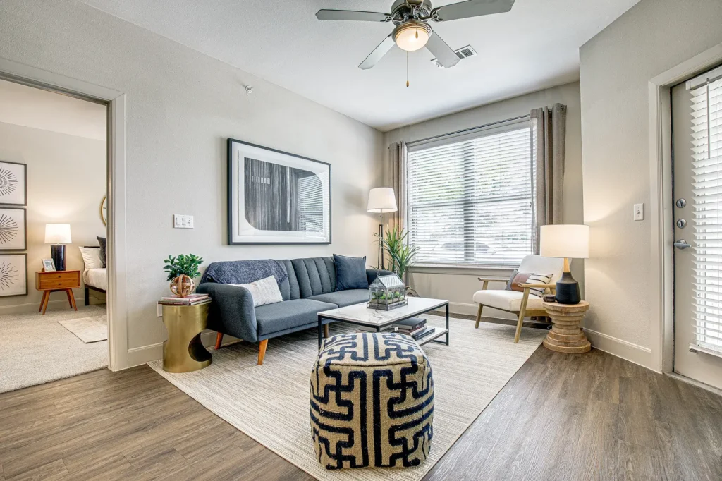 Open living room with large windows and ceiling fan