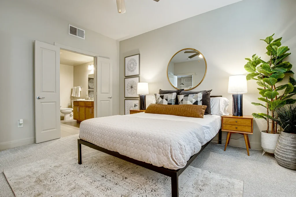 Carpeted bedroom with private bathroom