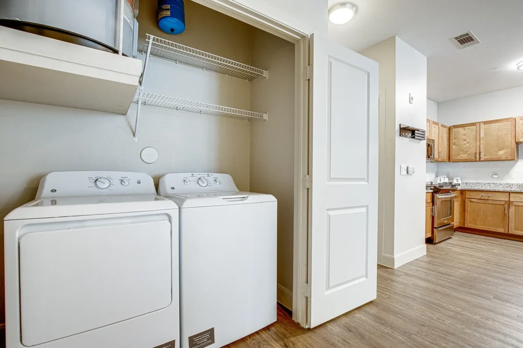 Laundry closet next to the kitchen with washer and dryer