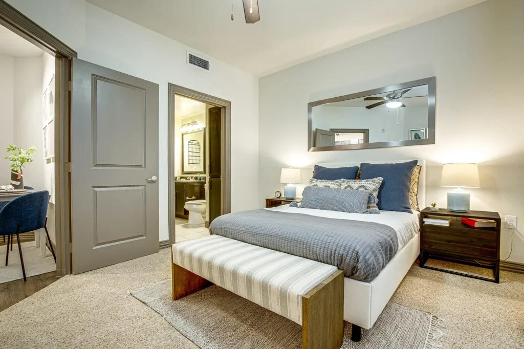 Carpeted bedroom with private bathroom